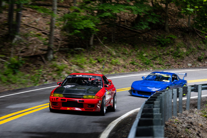 A Nissan Skyline and Mazda RX7 battle on the mountain