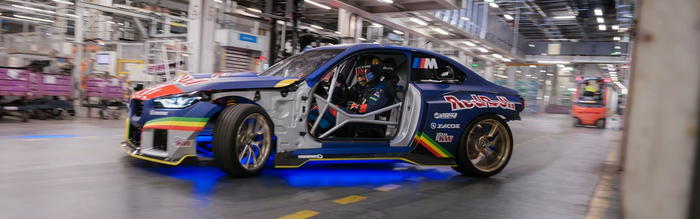 BMW M2 Drift Competition, heavily modified with 1100 horsepower, drifting and producing tire smoke inside the production hall of the BMW Munich factory.